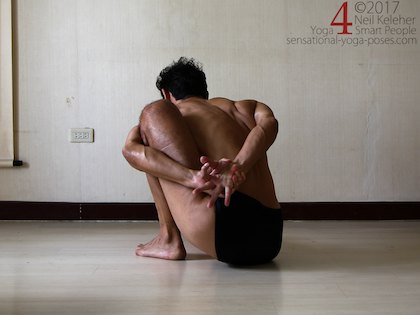 Binding in marichyasana a with arm pressing back against the shin. Neil Keleher. Sensational Yoga Poses.