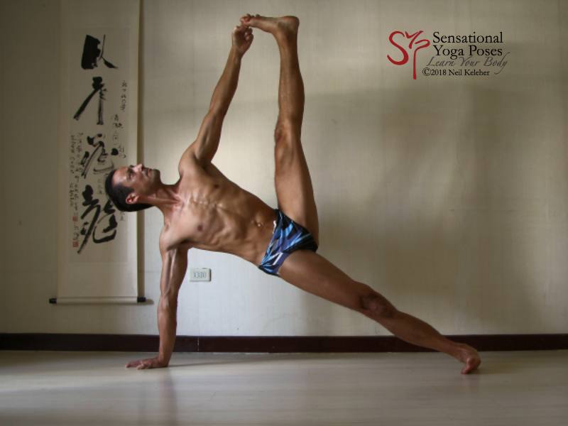 Side plank pose grabbing the top leg big toe Side plank yoga pose: elbows and knee are straight. Torso is inline with the supporting leg. Supporting shoulder is stacked over support wrist. Top leg is flexed upwards with the big with grabbed by the same side hand. Gaze is directed upwards with head in line with the torso. Neil Keleher. Sensational Yoga Poses.